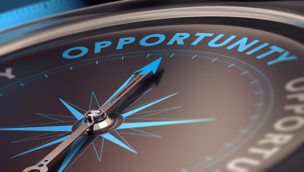 Compass with needle pointing the word opportunity, concept image to illustrate business opportunities and strategy.
