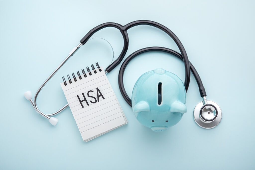 Health saving account, hsa concept, piggy bank with stethoscope on pastel blue background, top view