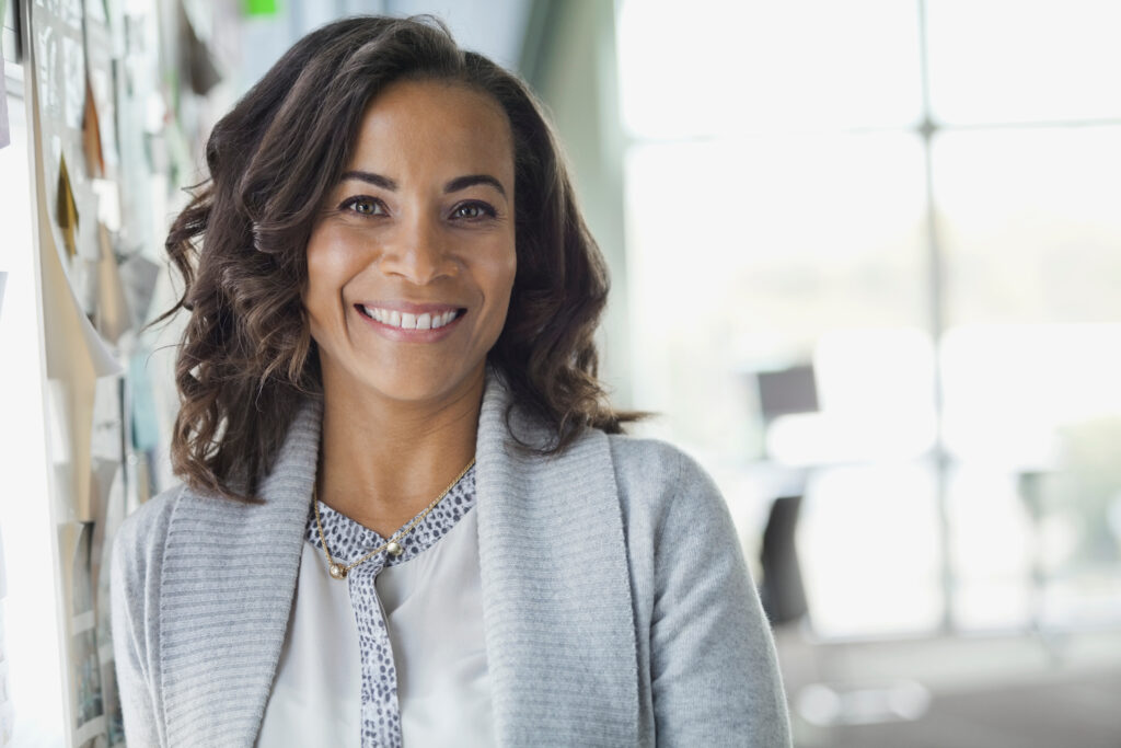 Portrait of confident businesswoman smiling in office