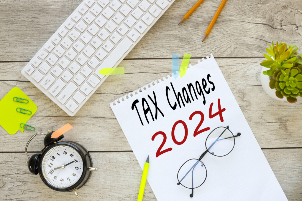 TAX CHANGES 2024. text on notepad with spring near white keyboard