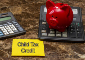Memo stick with words Child tax credits. Financial Saving Concept